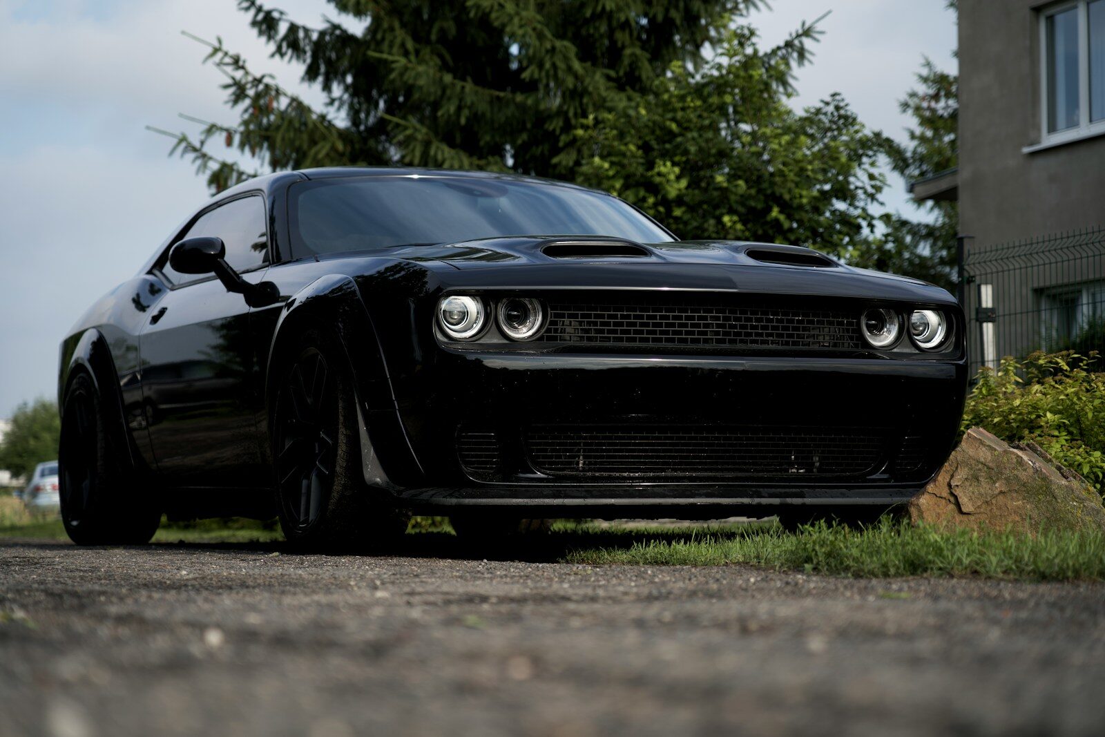 a black car parked on the side of a road