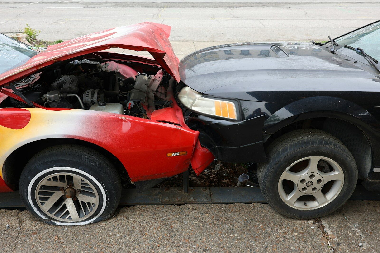 Cars are involved in a frontal collision.