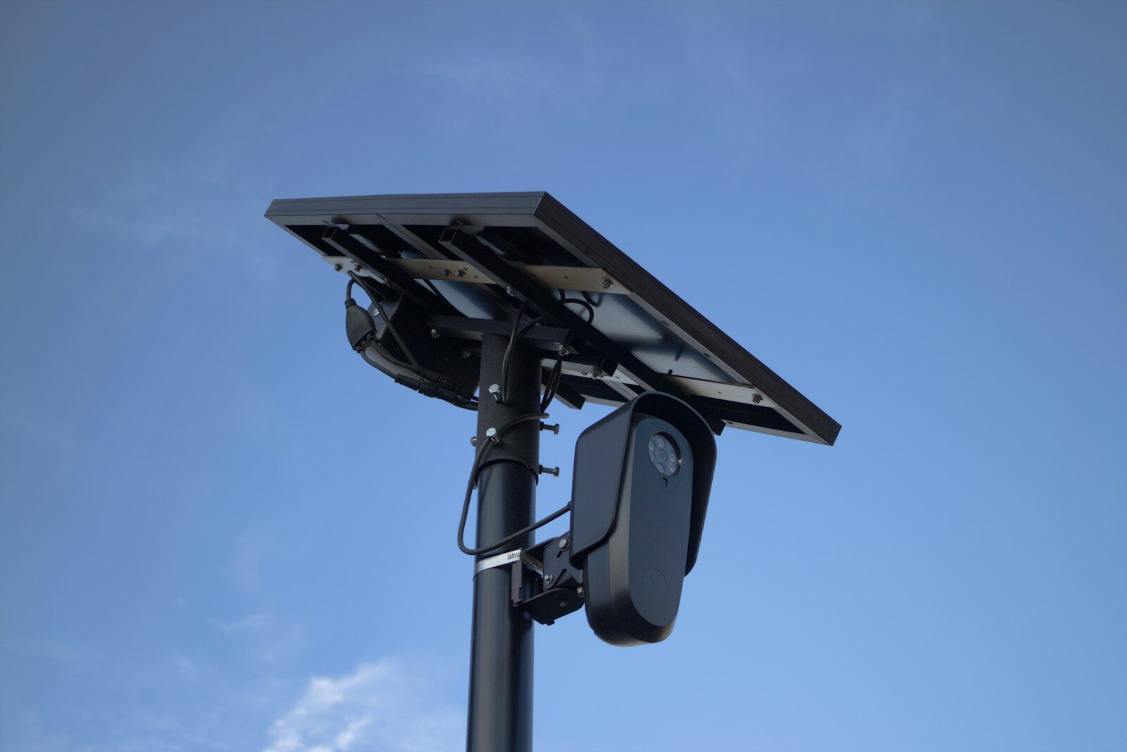 A solar panel powers a security camera.