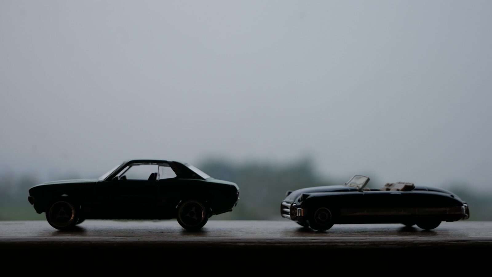 A couple of cars sitting next to each other on a road