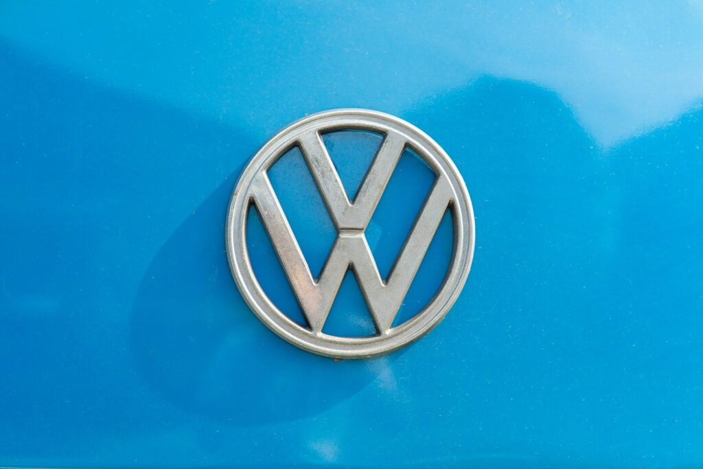 a close up of a volkswagen emblem on a blue car