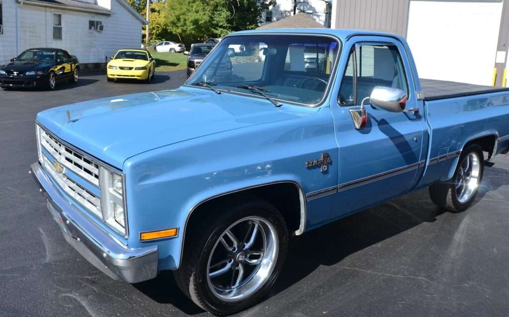 A classic blue pickup truck parked outdoors.