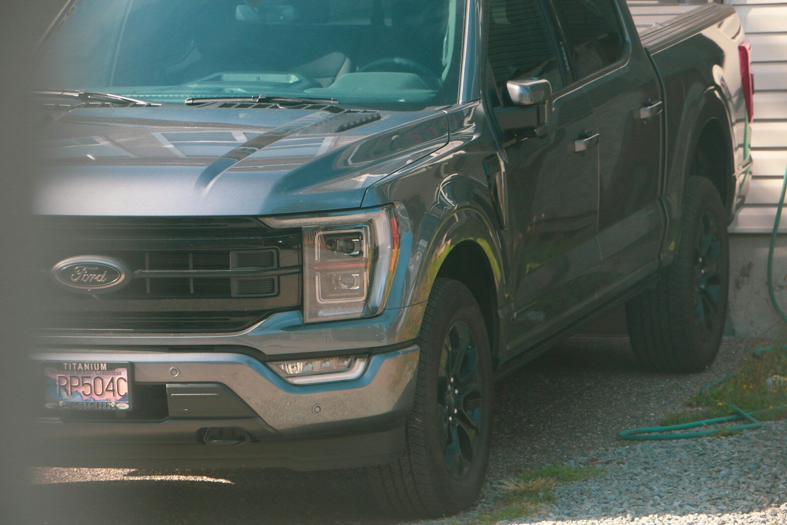 a black truck parked in front of a house