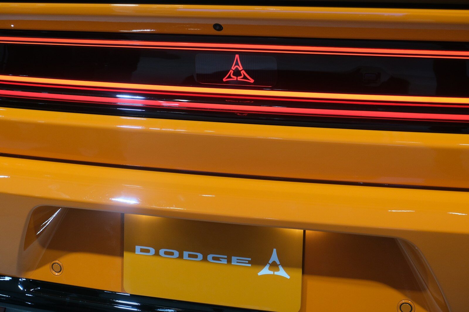 A close up of the hood of a yellow sports car