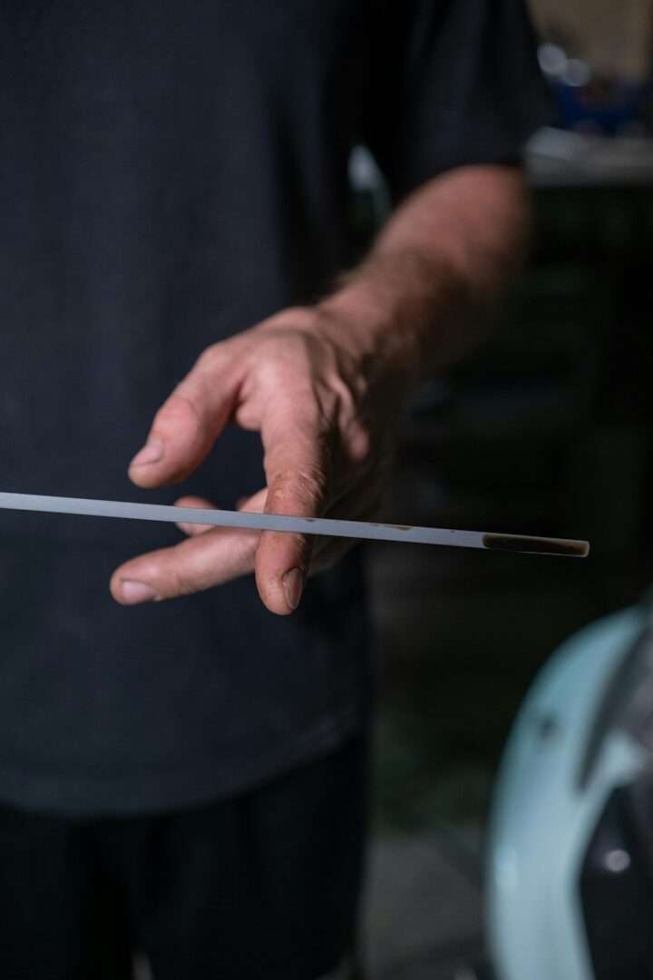 Man checking car oil with dipstick