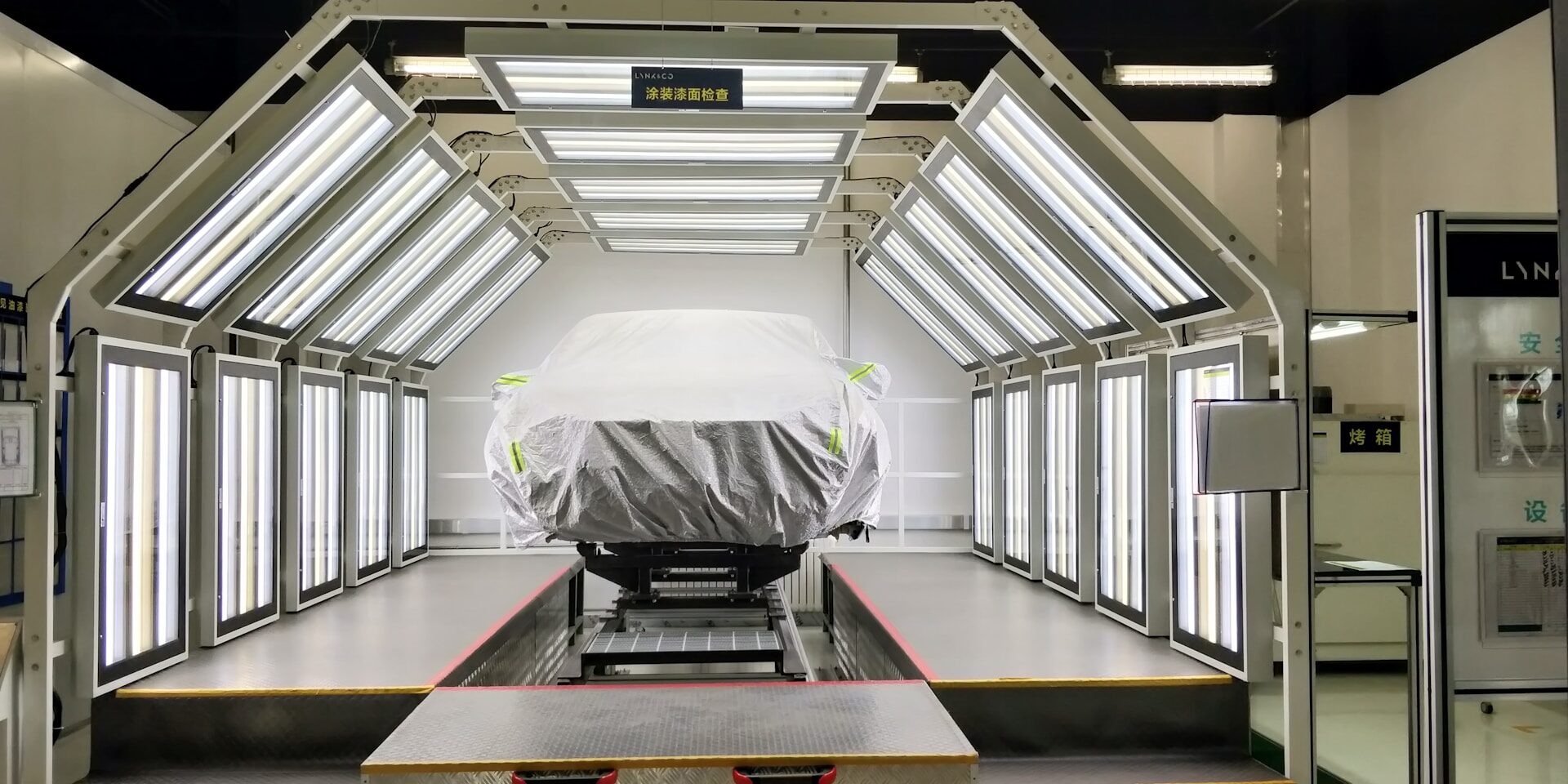 a car covered with a tarp is parked in a garage