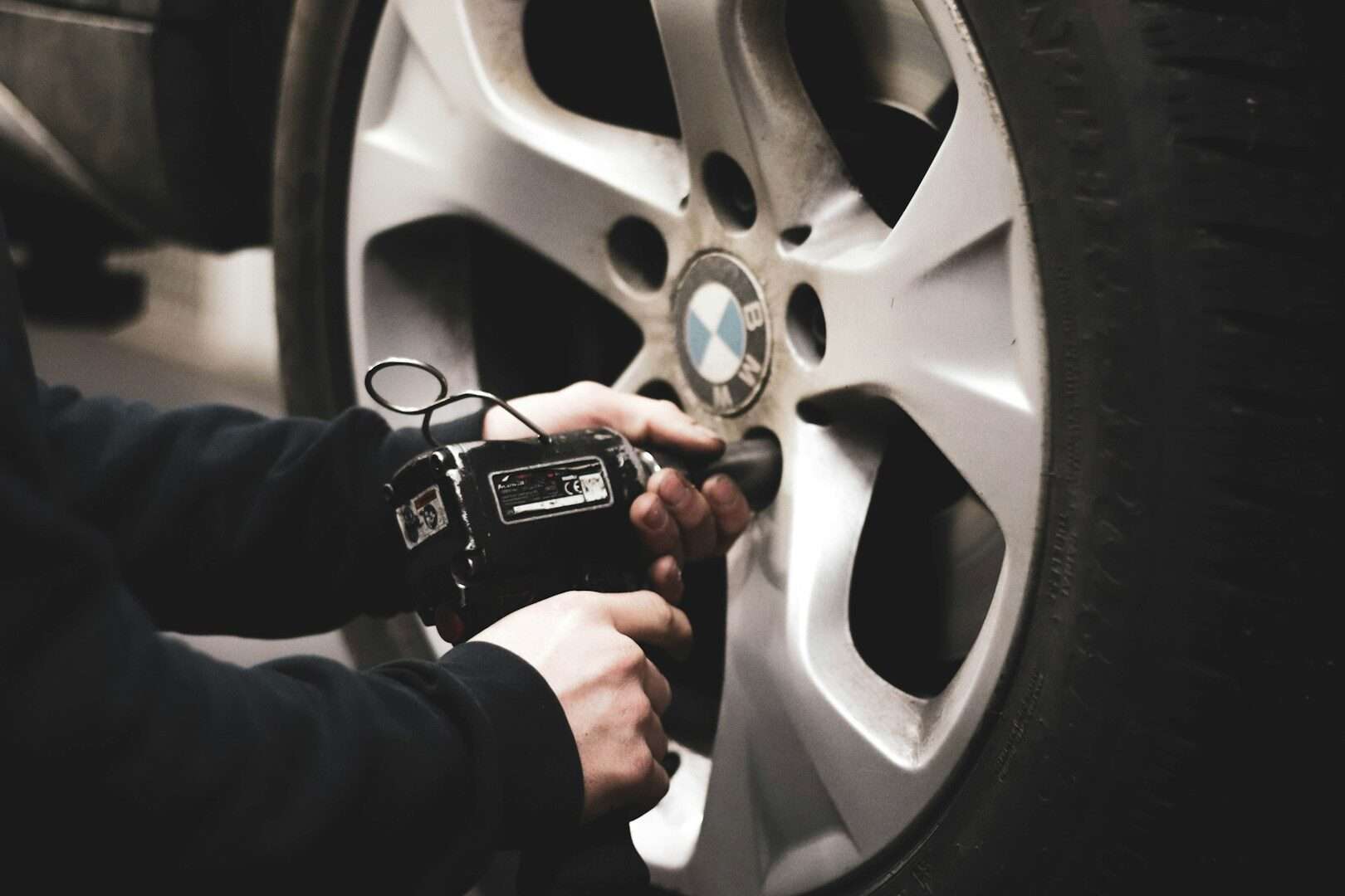 Checking car tire pressure with a gauge