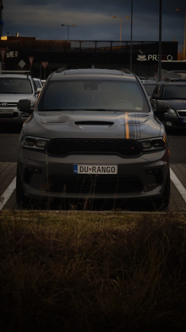 A car parked in a parking lot at night