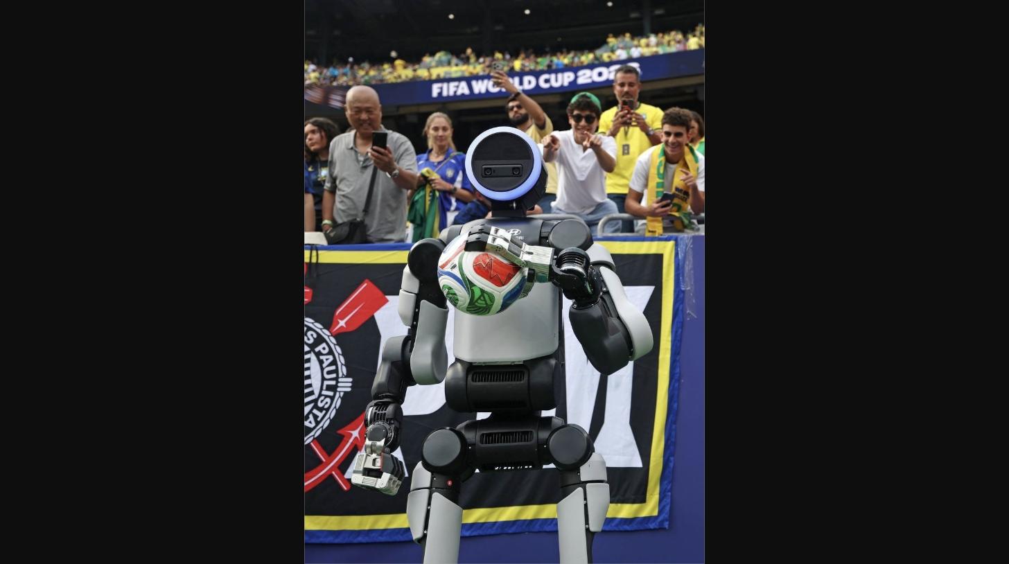 Boston Dynamics' Atlas humanoid robot holds the match ball during Hyundai's FIFA World Cup 2026 halftime show