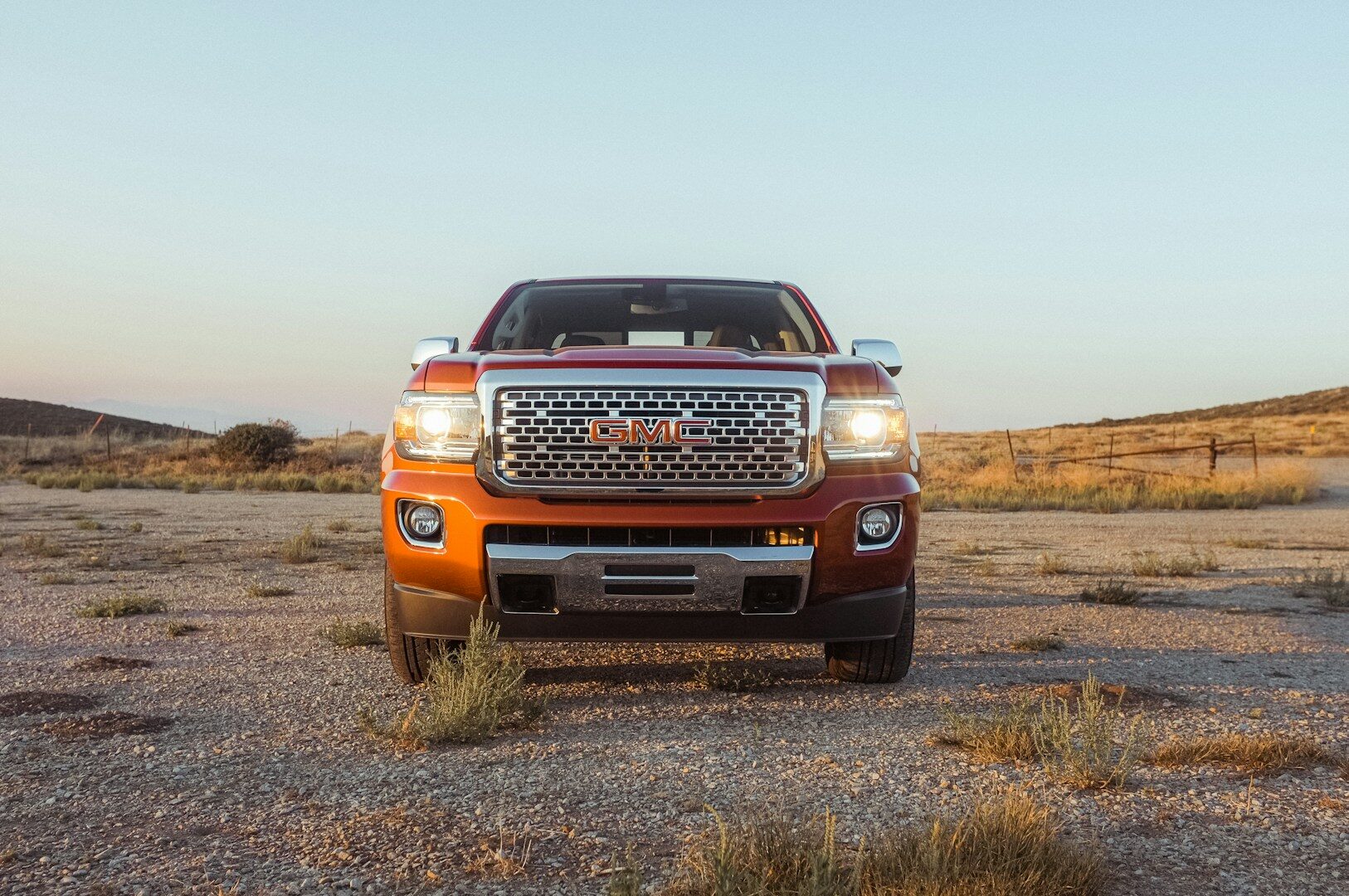 GMC pickup truck parked in a desert landscape