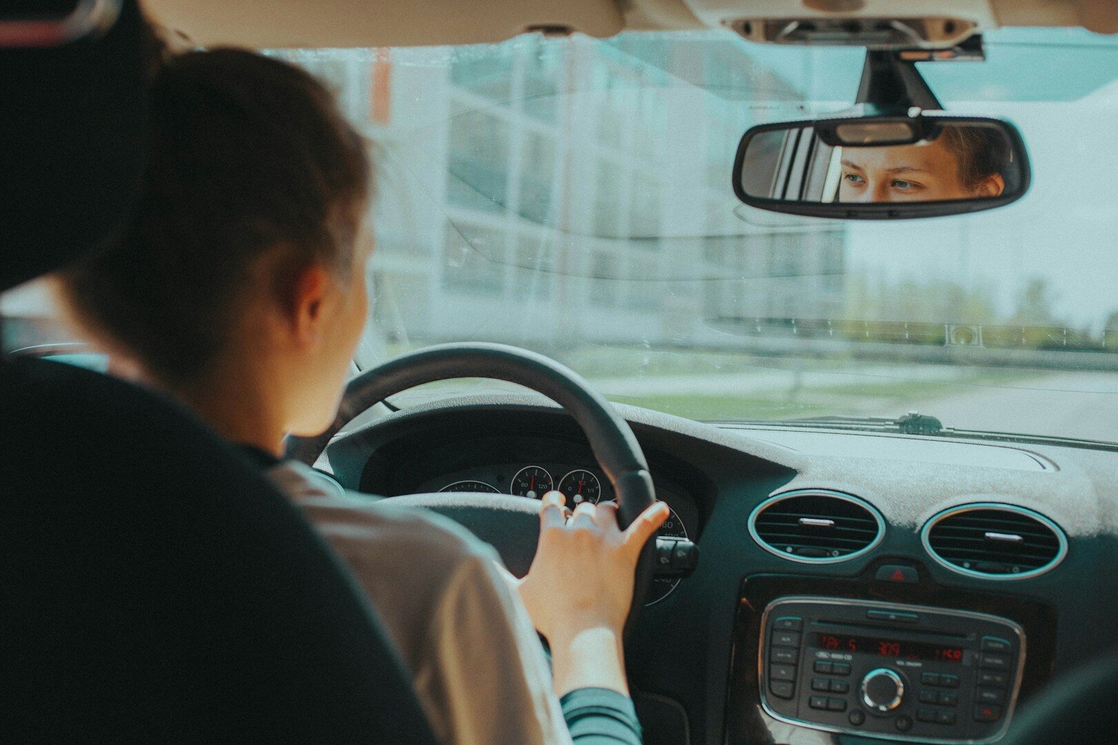 Teen driver behind the wheel, illustrating teen car weight safety criteria