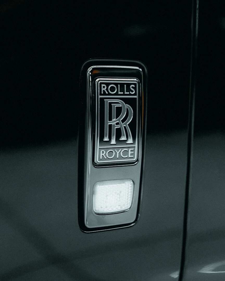 a rolls royce emblem on the door of a rolls royce car