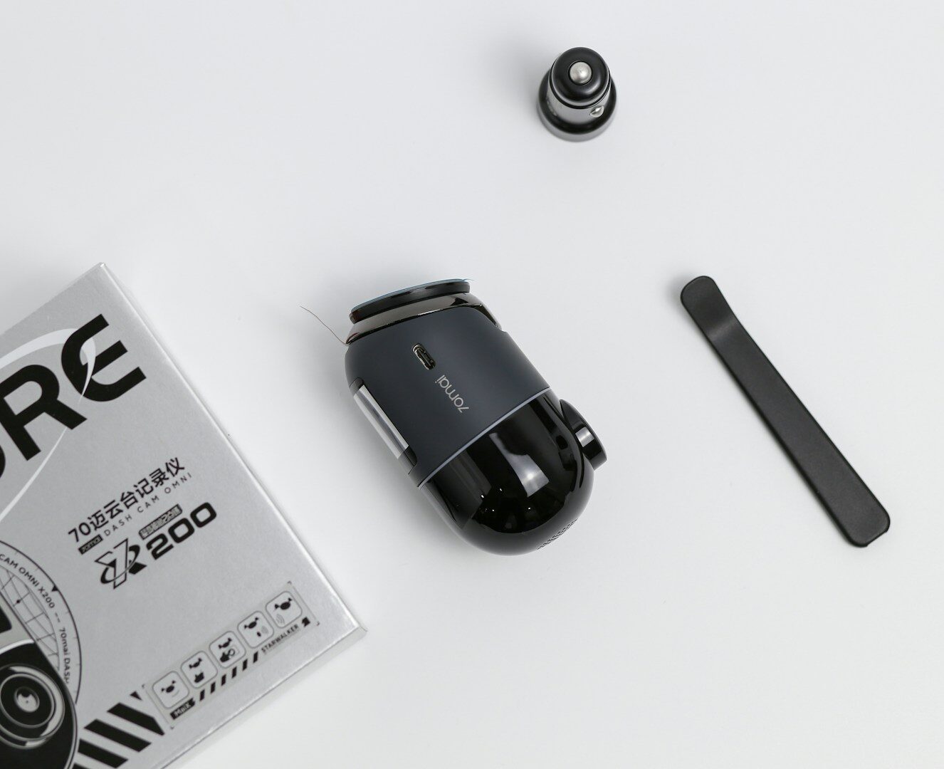 A camera and accessories laid out on a table