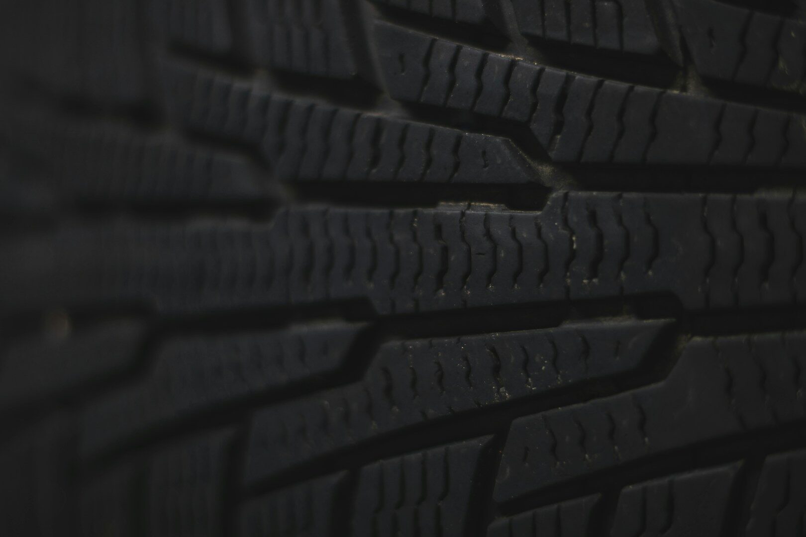 Close-up of a dark tire tread pattern