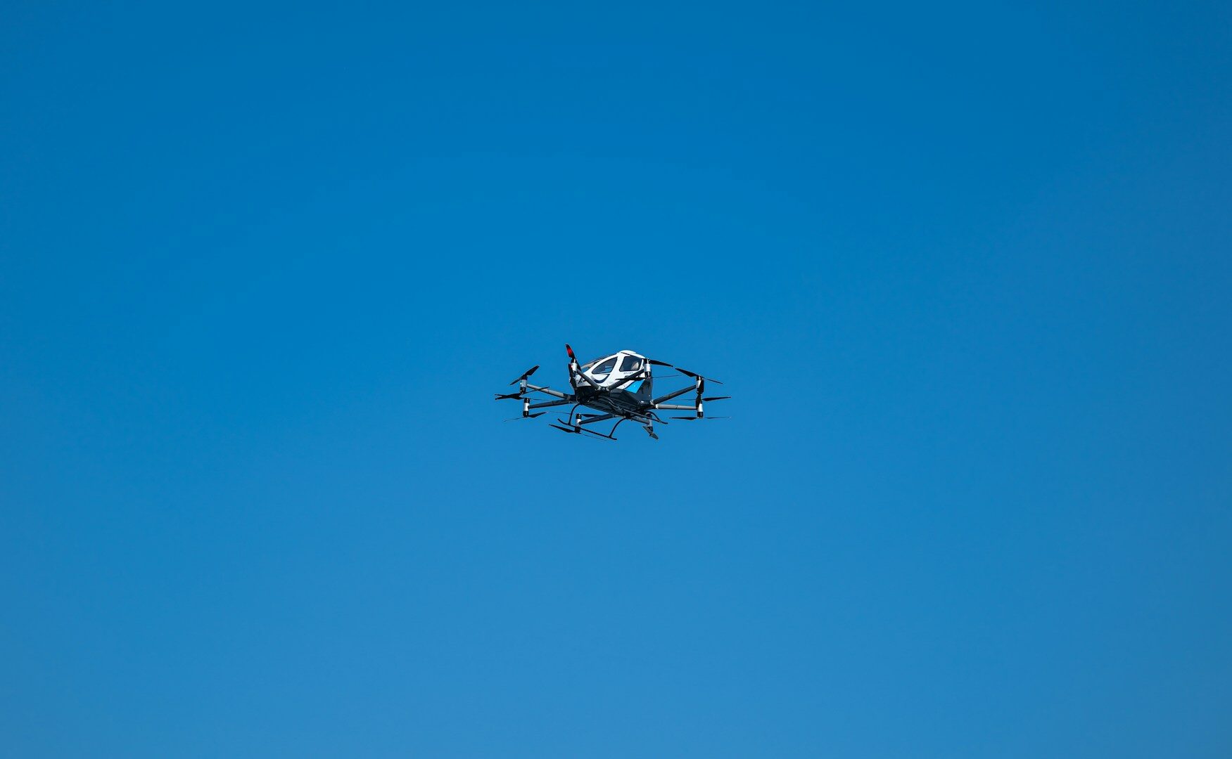 A small propeller plane flying through a blue sky