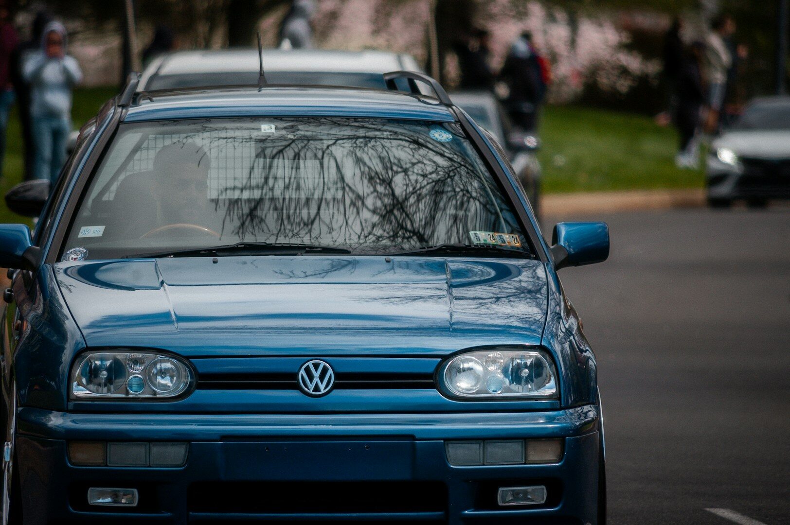 a blue car is parked on the side of the road