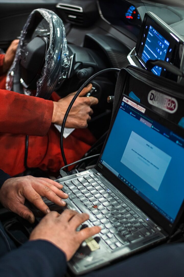 Independent mechanic uses a laptop-based diagnostic tool to access vehicle repair data