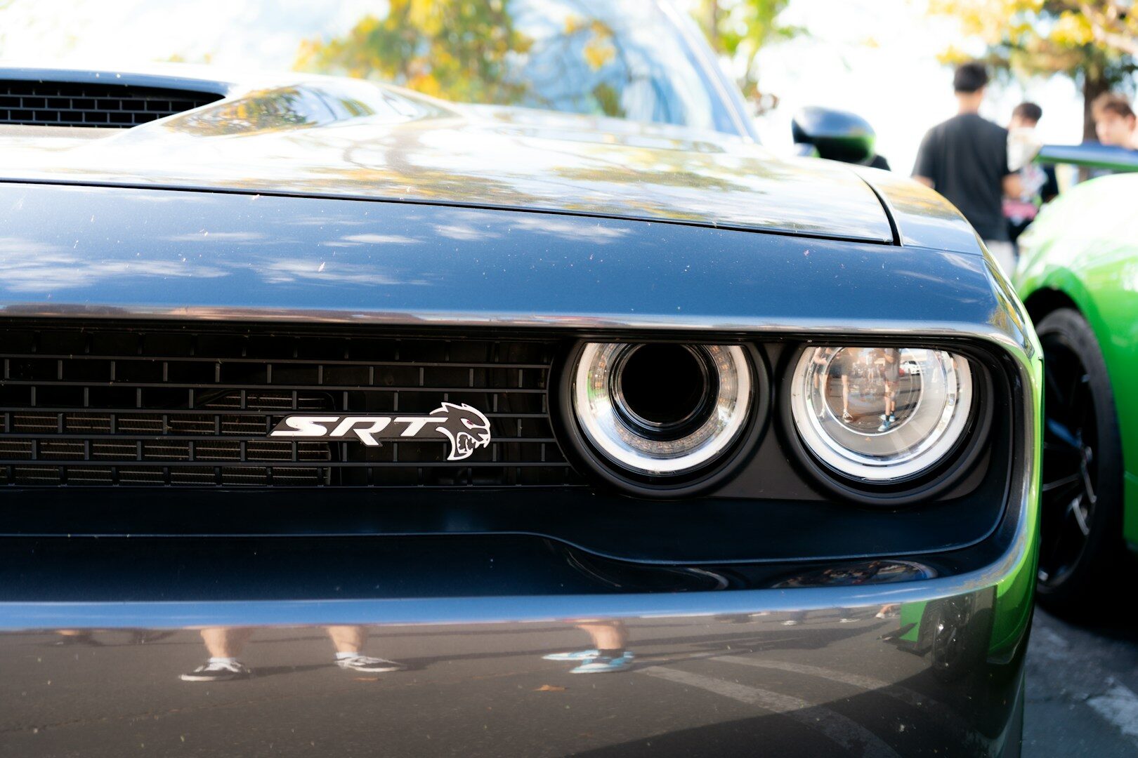 Dark gray srt car's front grille and headlights.