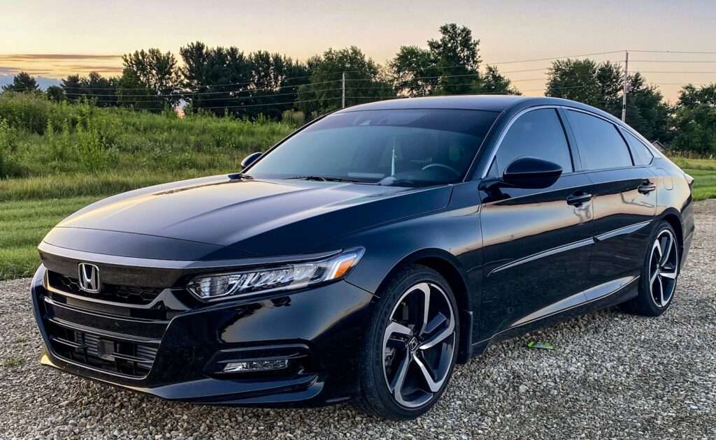 A black 2019 Honda Accord Sport parked on a gravel road
