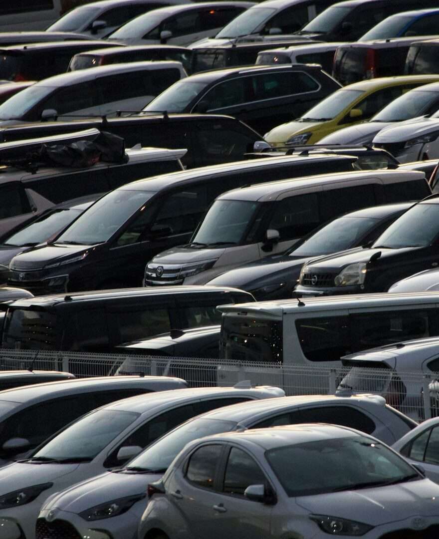Rows of new crossovers and SUVs parked tightly on a dealer storage lot