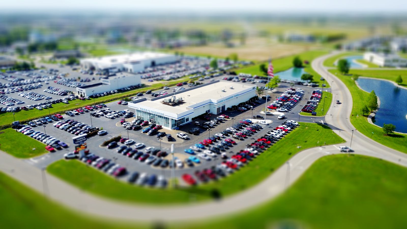High angle view of a busy car dealership lot filled with new vehicles