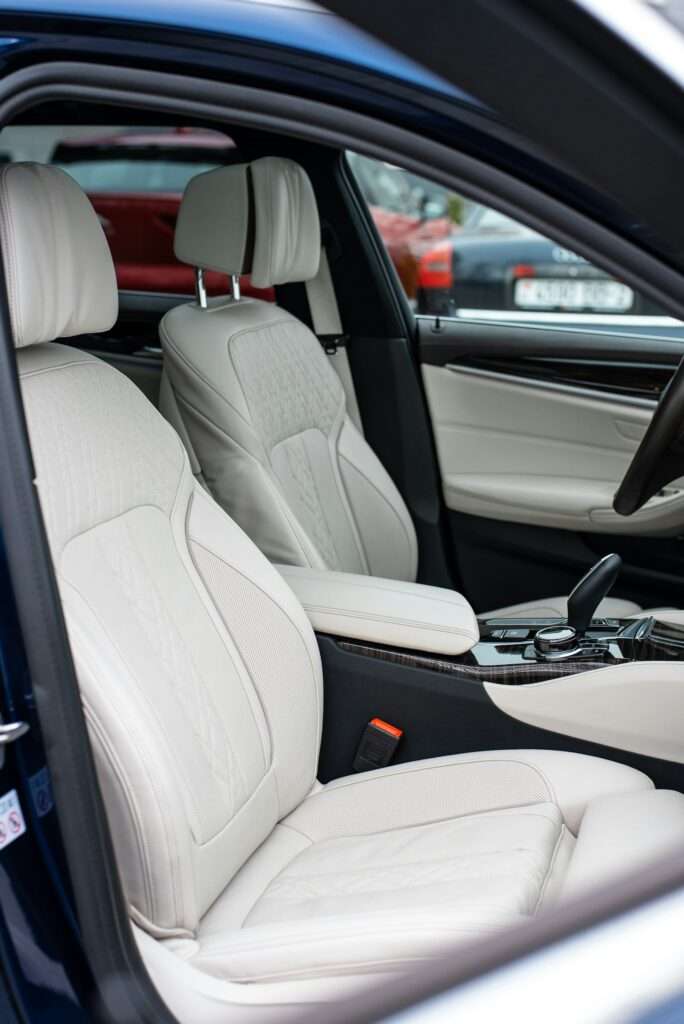 Front seats inside a modern German sedan, whose steel seat frames are hidden under the upholstery