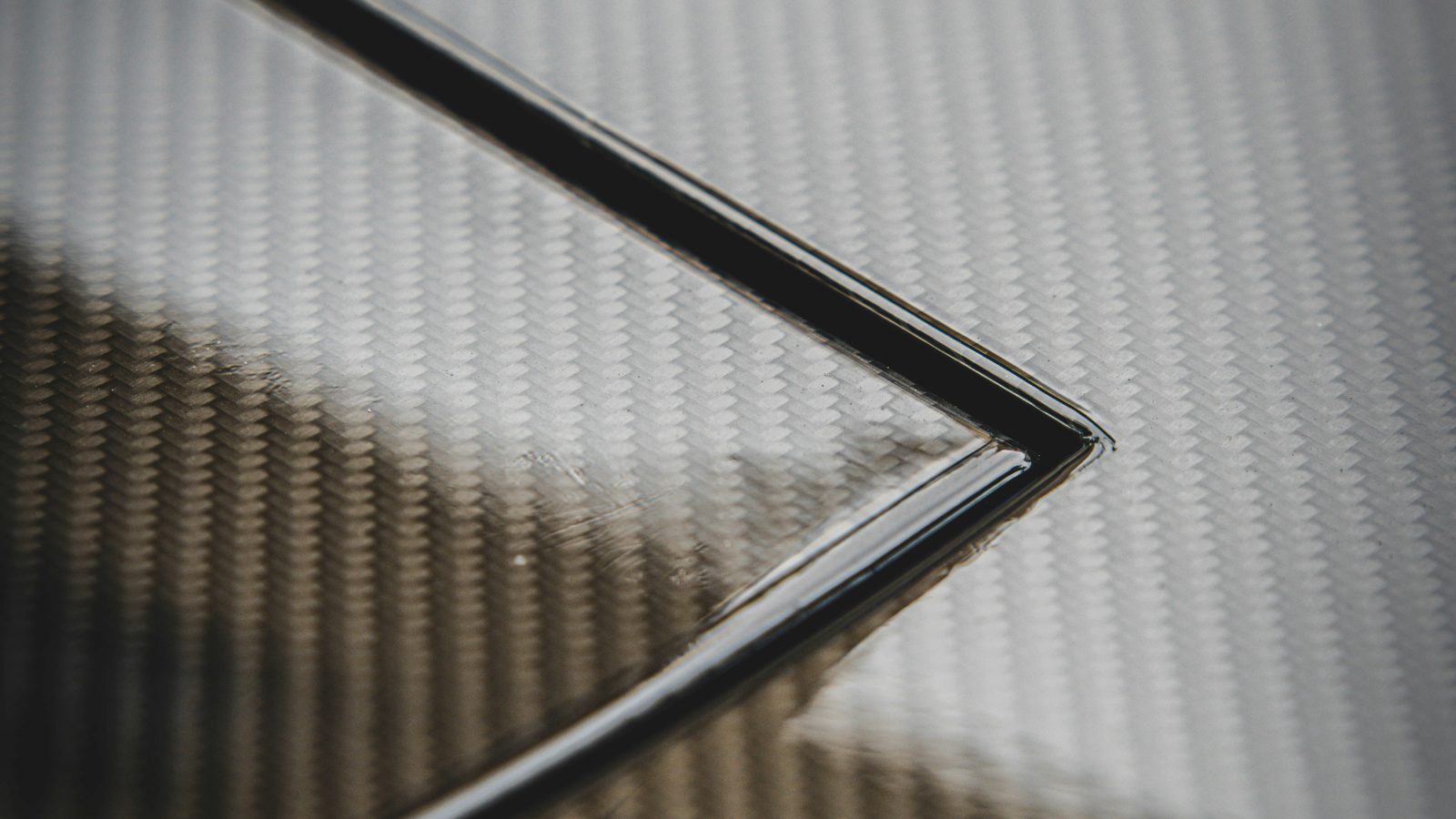Close-up of a woven carbon fiber composite surface