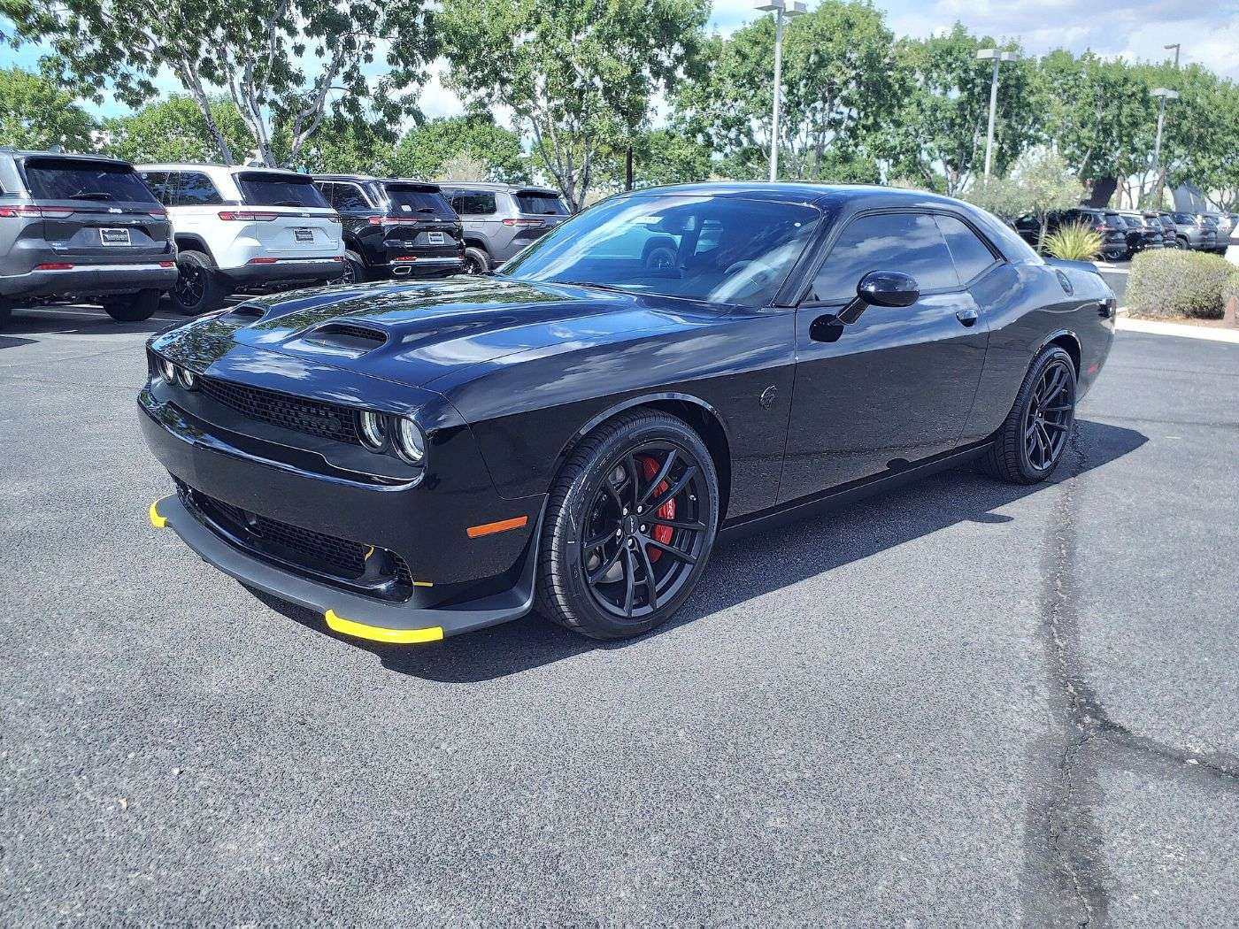A dark 2023 Dodge Challenger SRT Hellcat parked in a lot