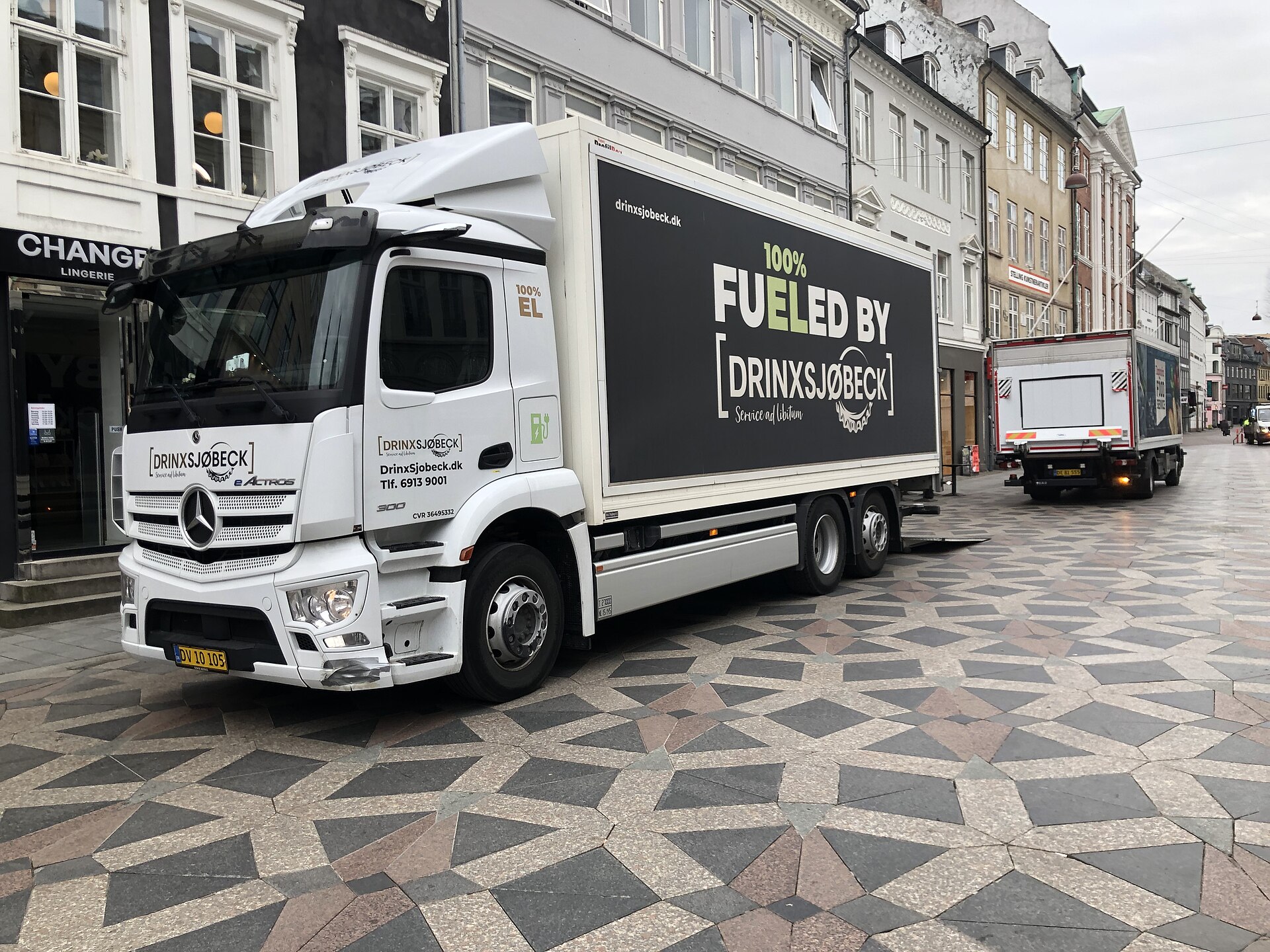 Battery-electric heavy-duty semi truck parked on a city street