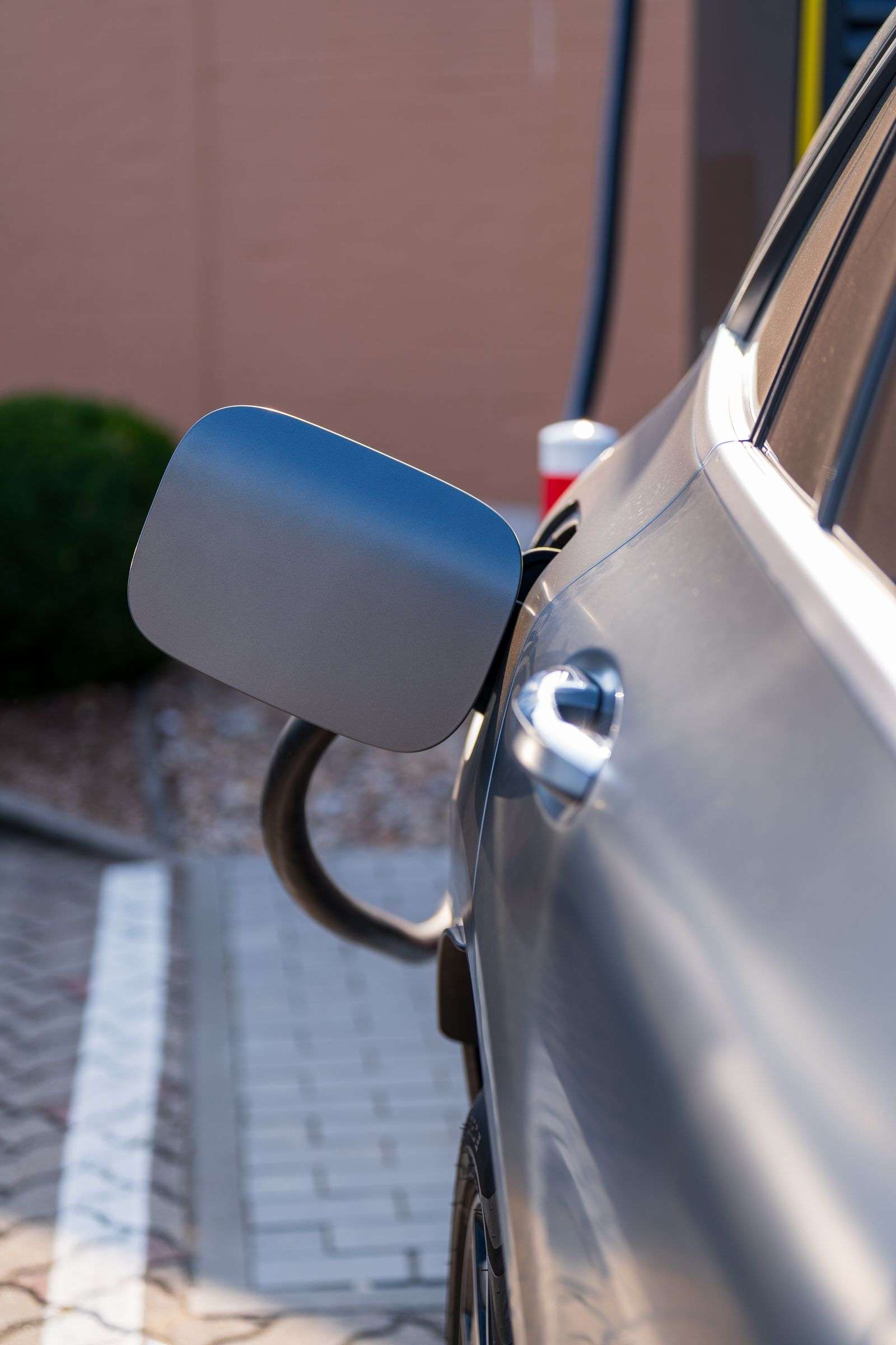 Close-up of an electric vehicle's charging port with cable connected
