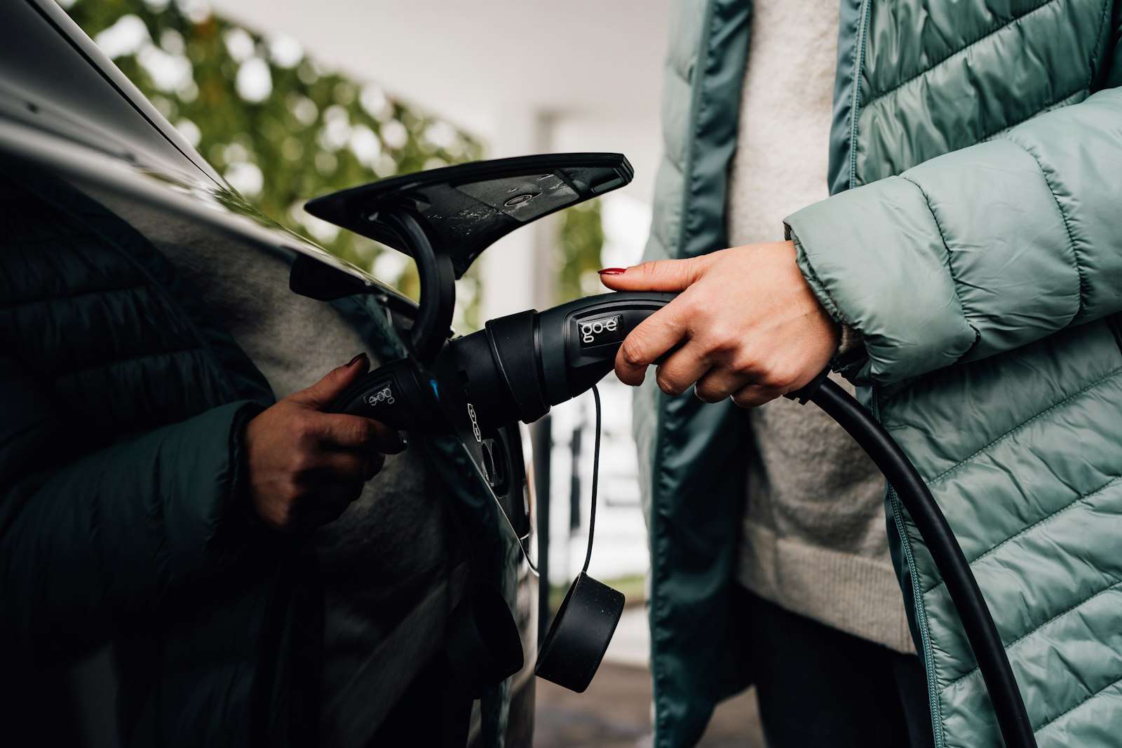 Charging cable being plugged into an electric car