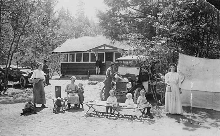 1920s postcard of families camping beside their automobiles at the free auto camp ground in Lithia Park, Ashland, Oregon
