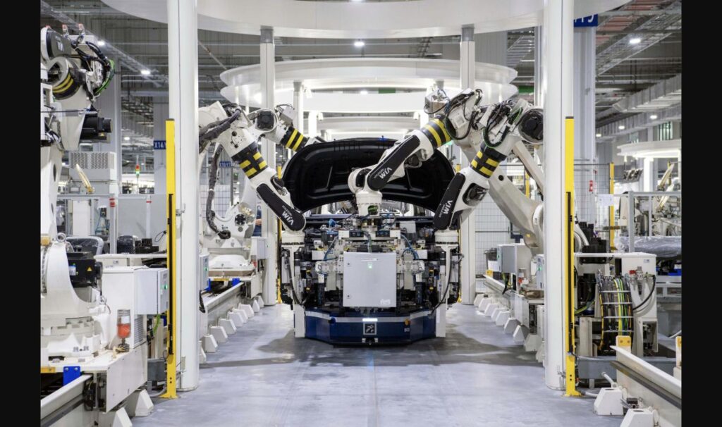 Robotic arms assembling a car body on an automaker's production line
