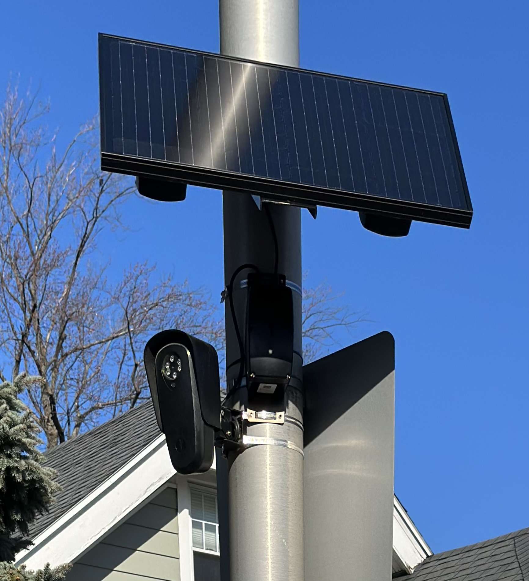 Solar-powered Flock Safety license plate camera on a pole