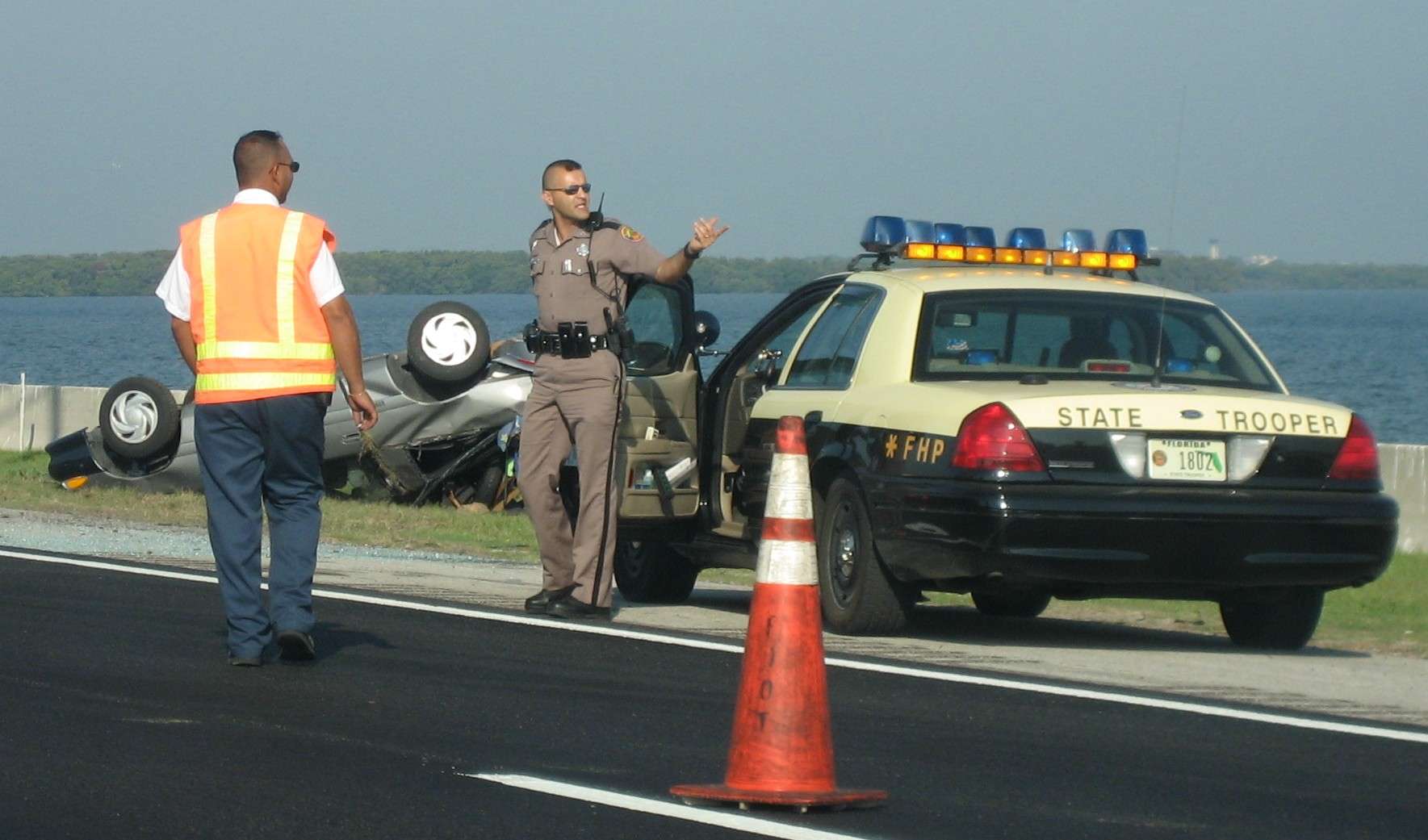 A Florida Highway Patrol cruiser with emergency lights on during a roadside stop