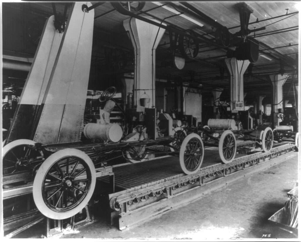 Workers on the moving assembly line at the Ford Motor Company Highland Park plant in 1913