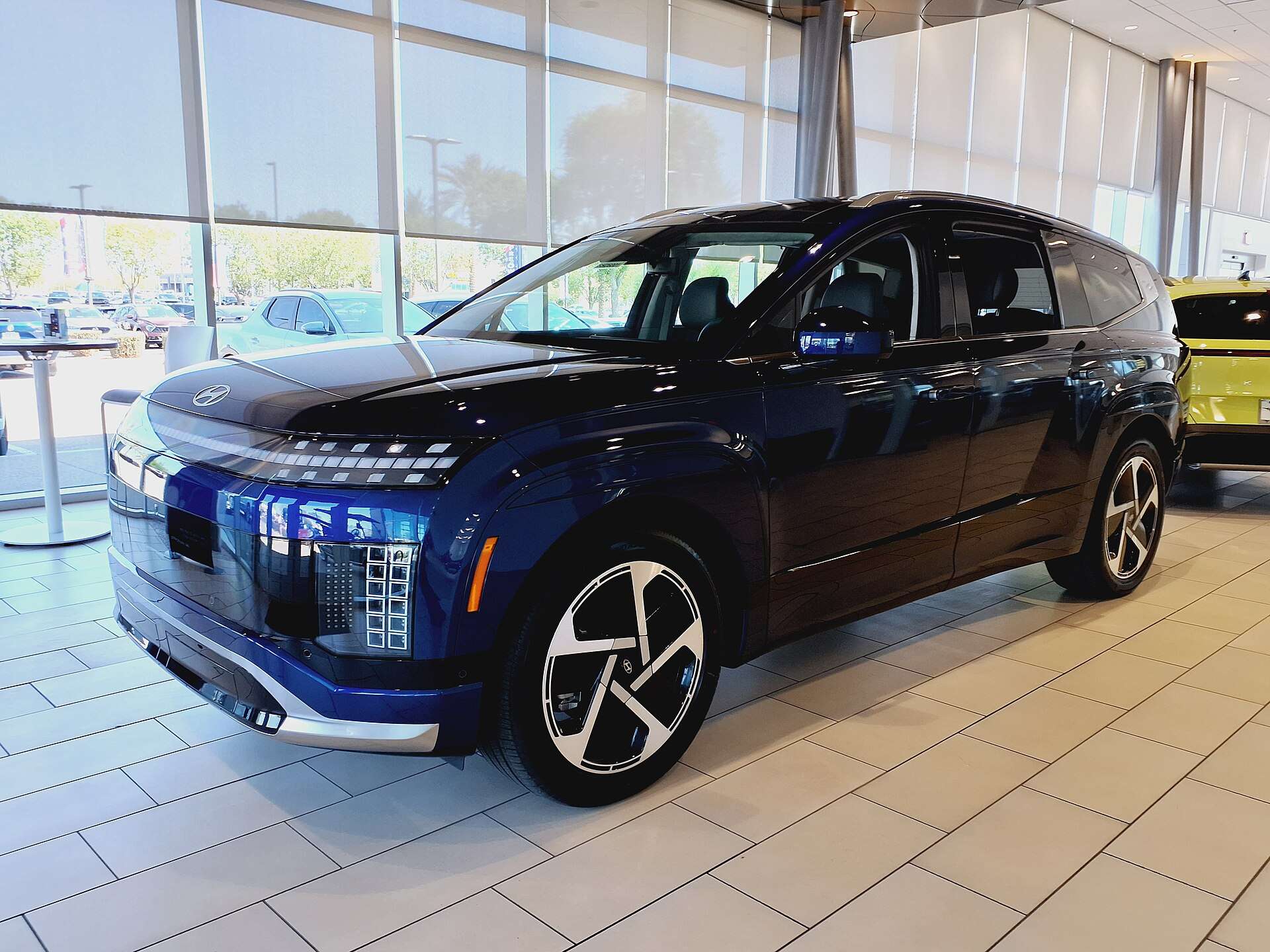 Blue 2026 Hyundai Ioniq 9 Performance Calligraphy parked in a dealer showroom