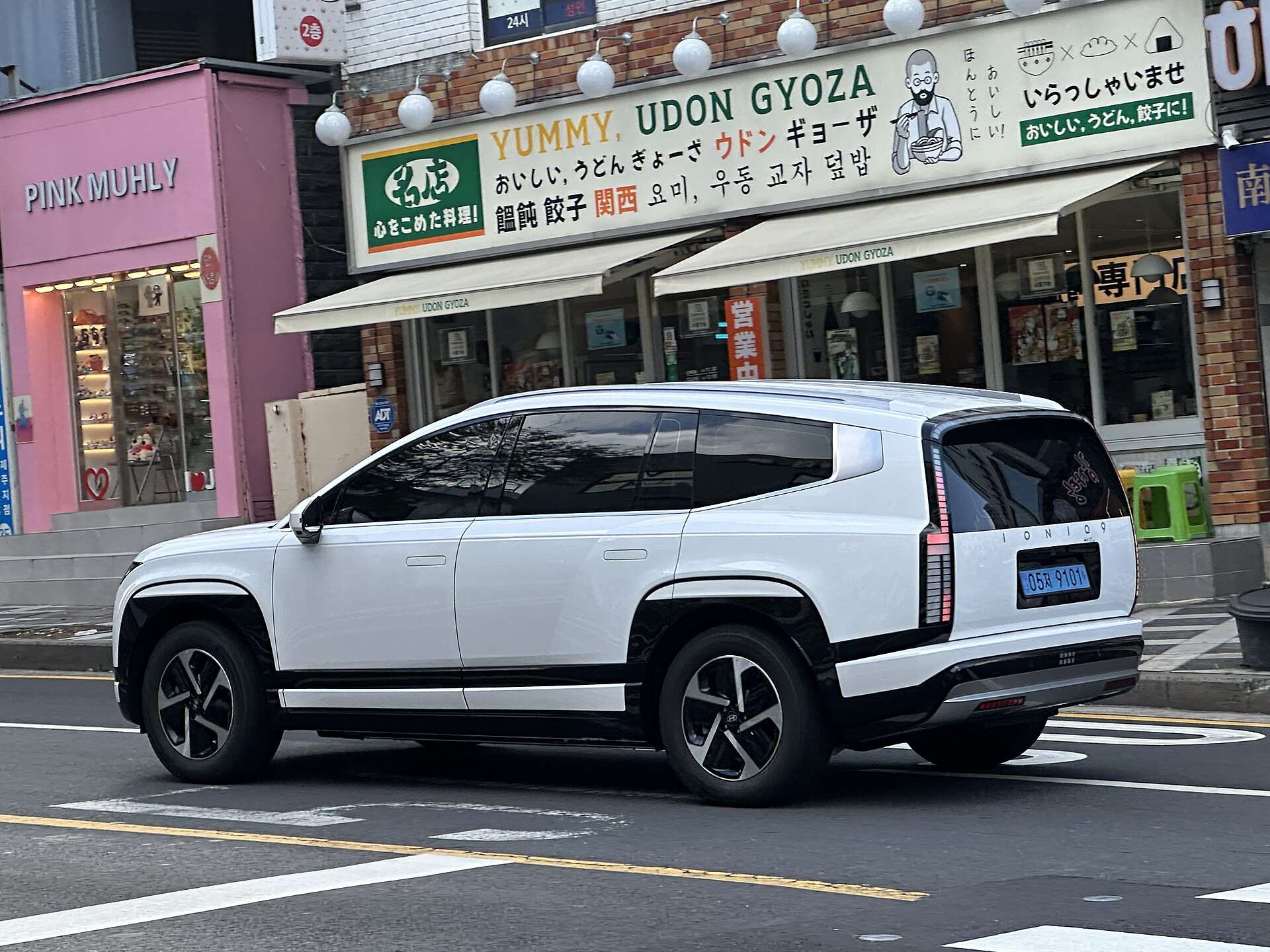 White Hyundai Ioniq 9 seen from the rear three-quarter angle on a city street