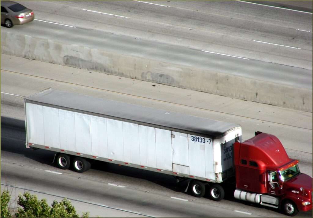 Semi trucks hauling freight eastbound on Interstate 10 in Redlands, California