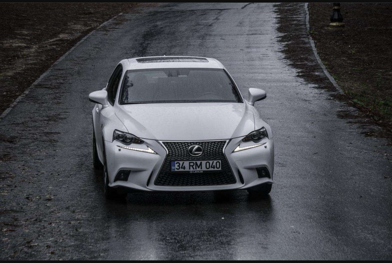 White Lexus sedan on a wet road, representing Japan's move into luxury cars