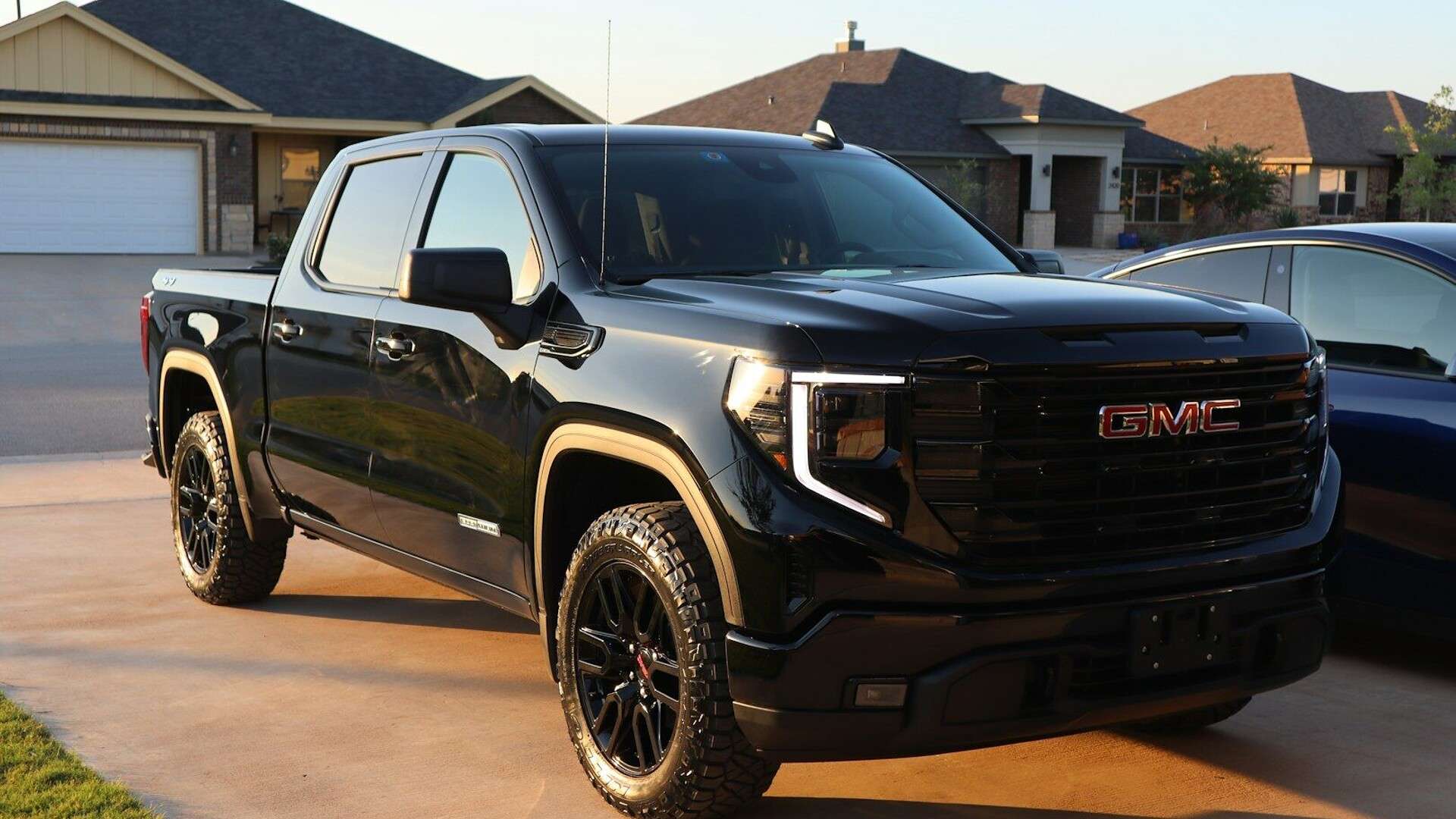 a black truck parked in a driveway