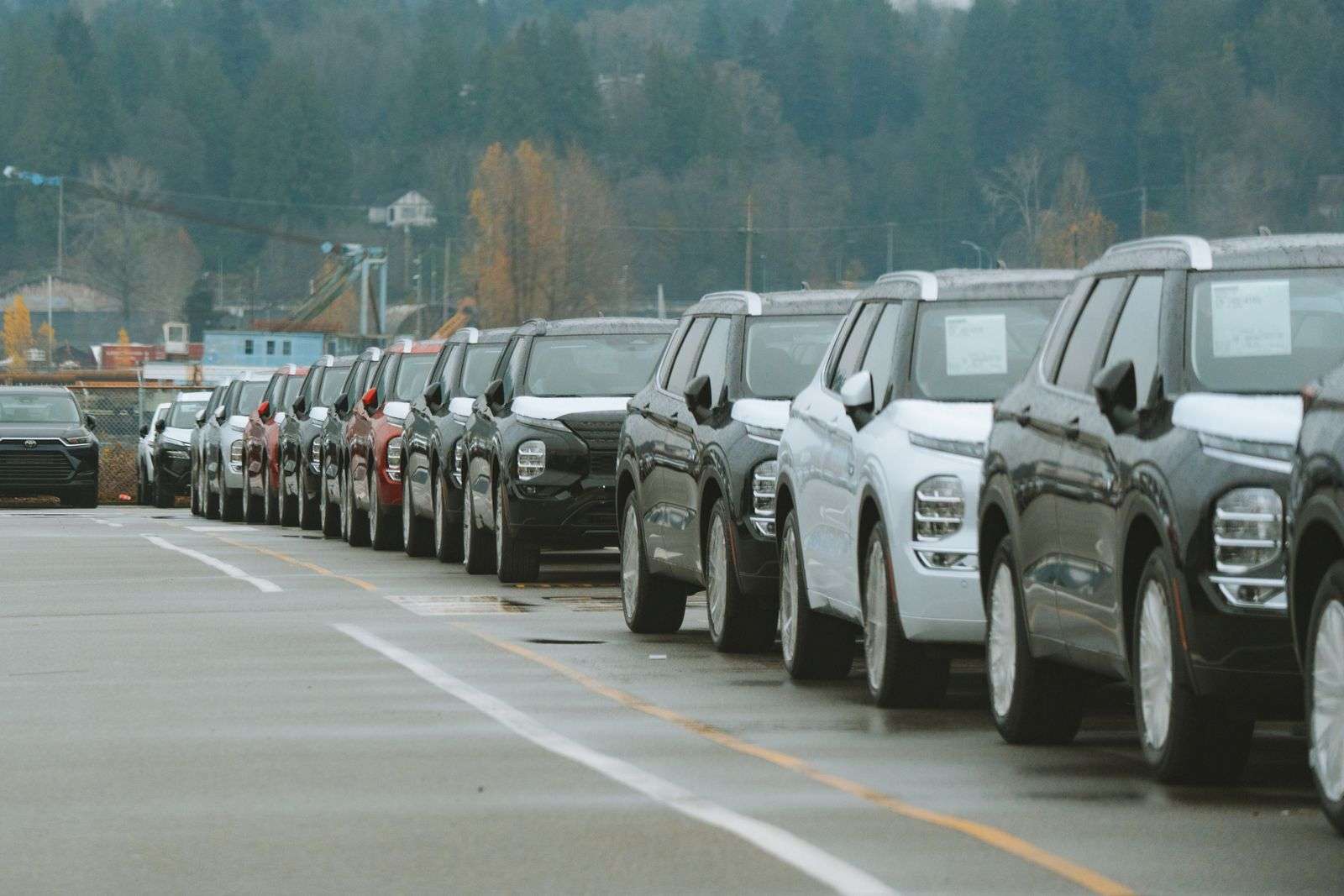 A row of new SUVs parked on an outdoor dealership lot