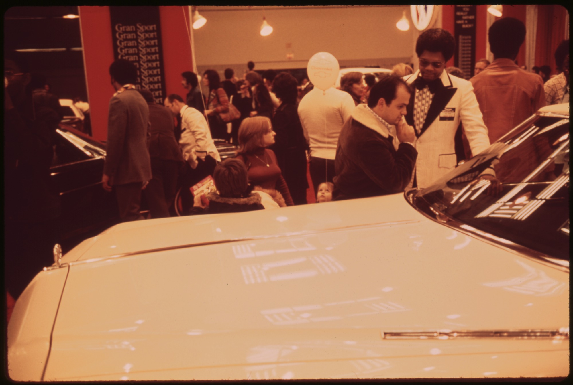 Shoppers looking at new cars on display at the New York Coliseum auto show in 1973