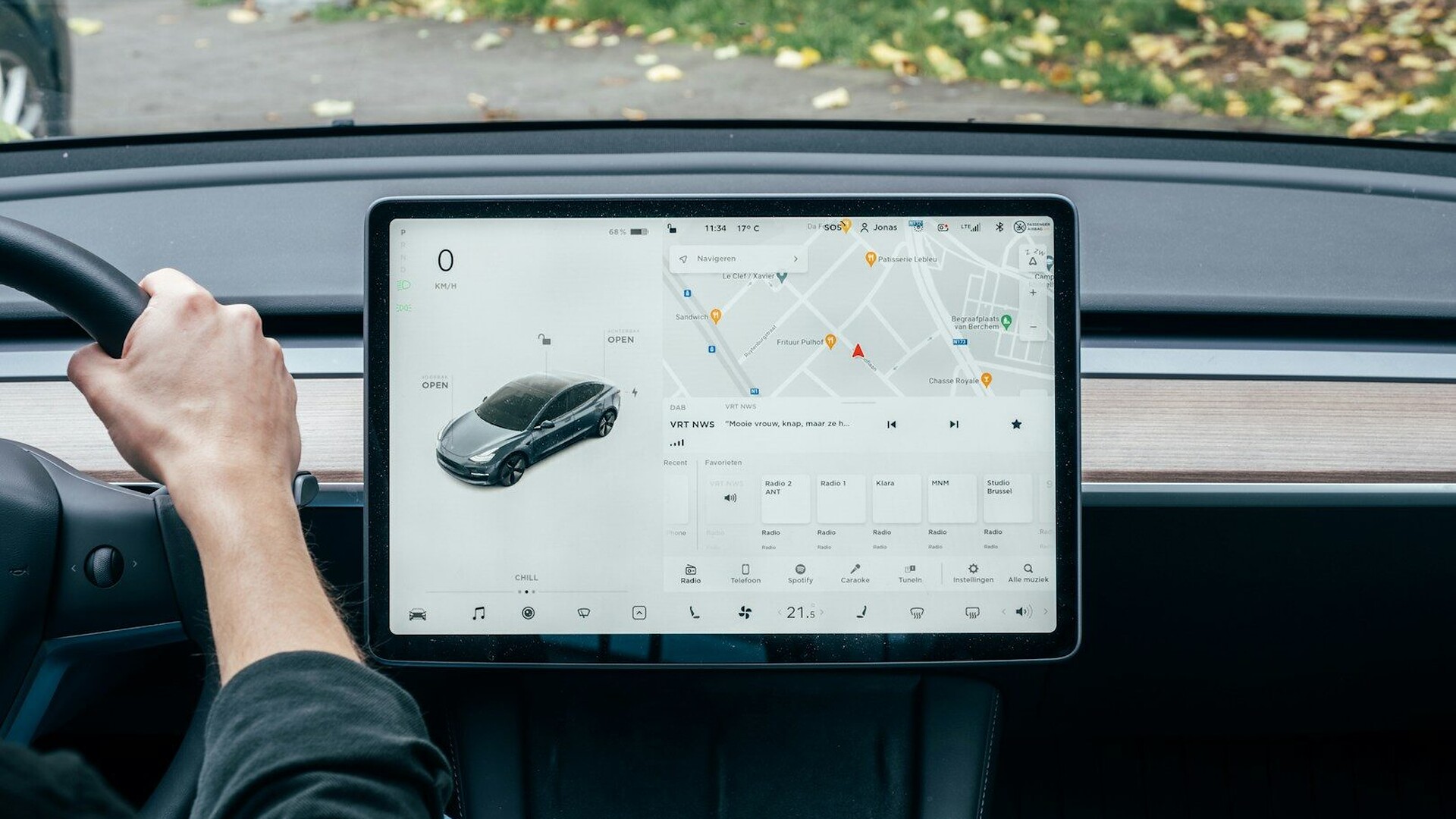 a person driving a car with a computer on the dashboard