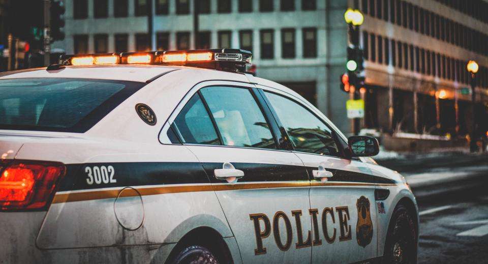 Police car with emergency lights on a city street