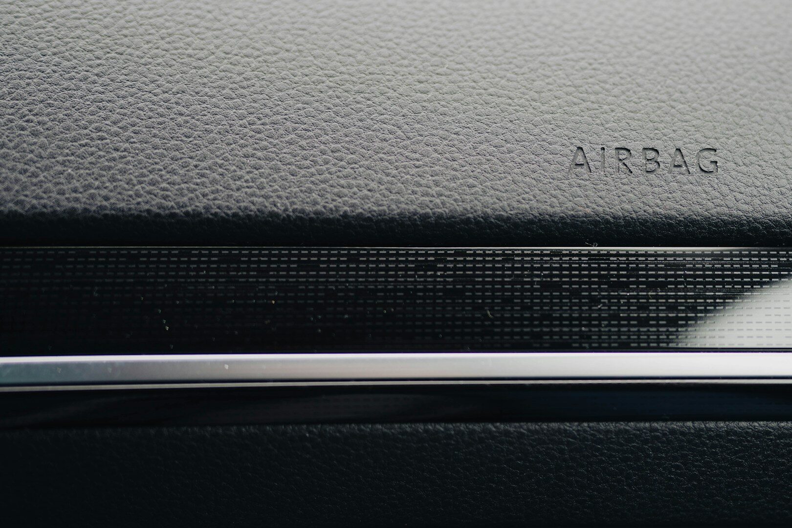 Close-up of a car's dashboard, showing "airbag."