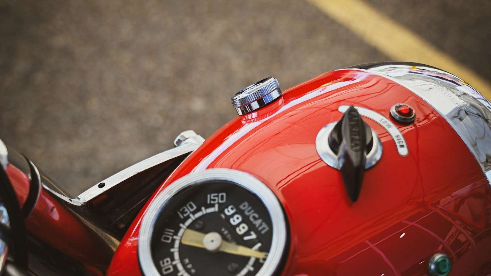 Fuel filler cap on the tank of a red vintage motorcycle
