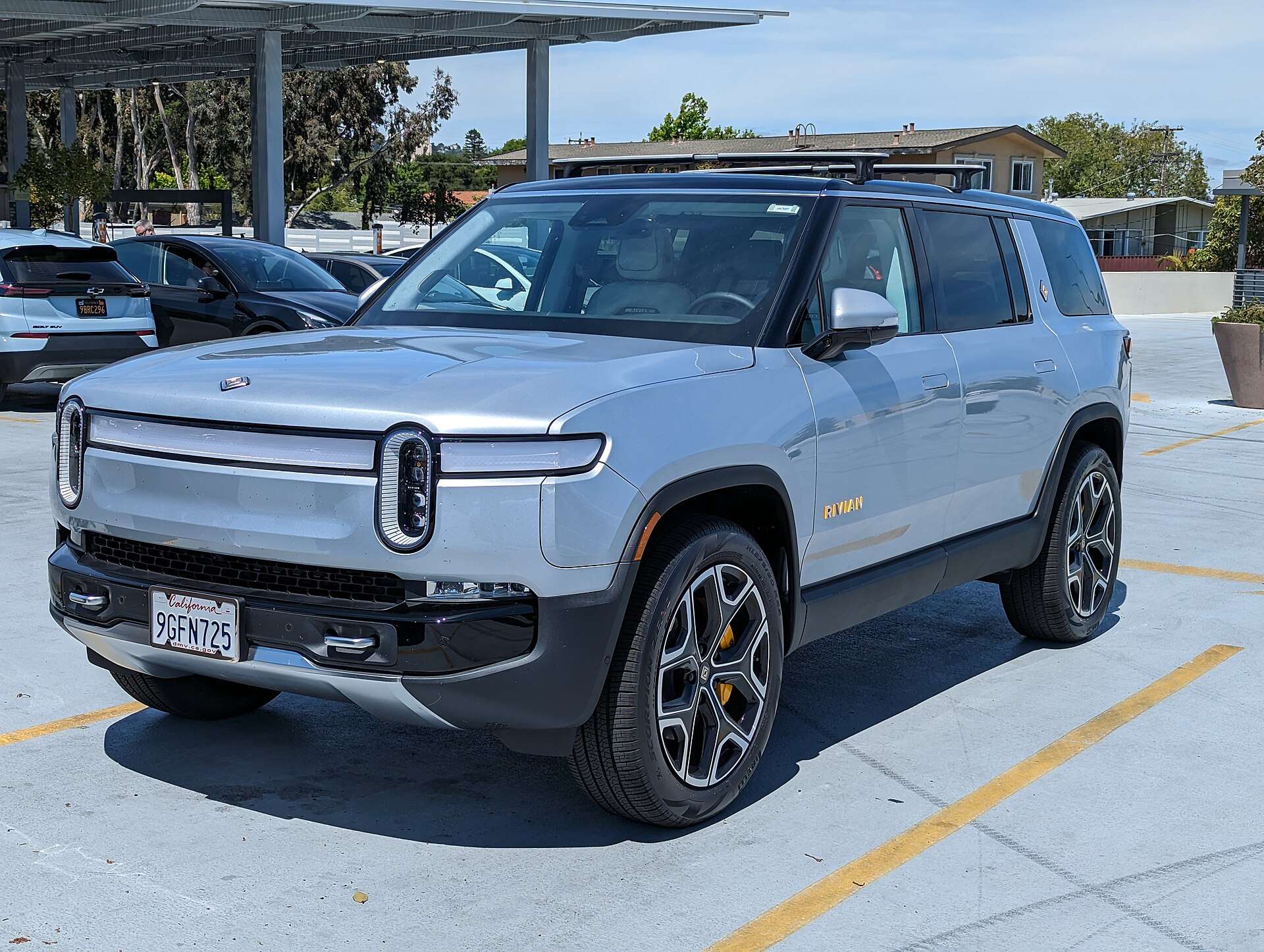 Rivian R1S electric SUV parked in a shopping center lot