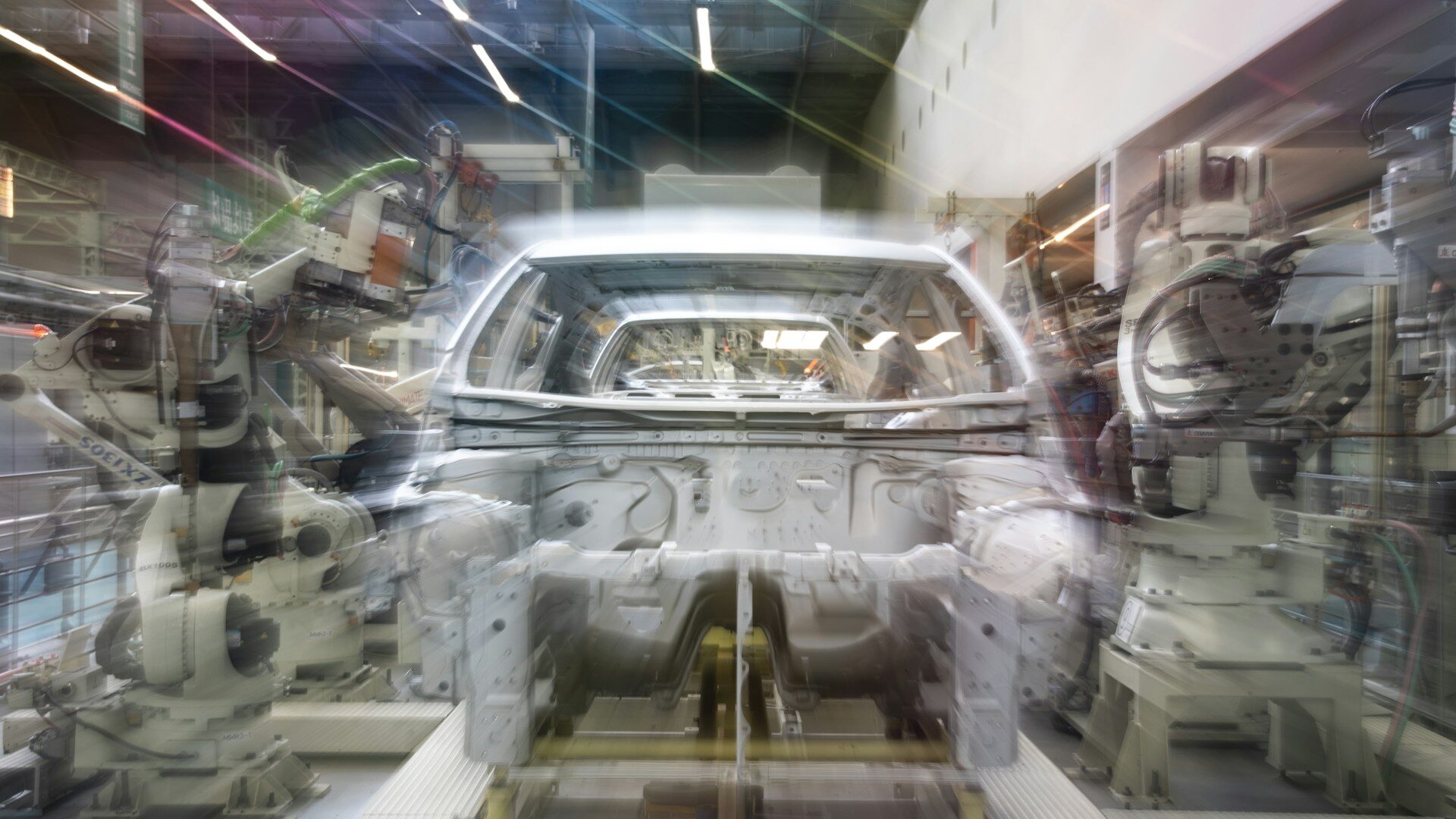 Car assembly line with robotic arms and car body