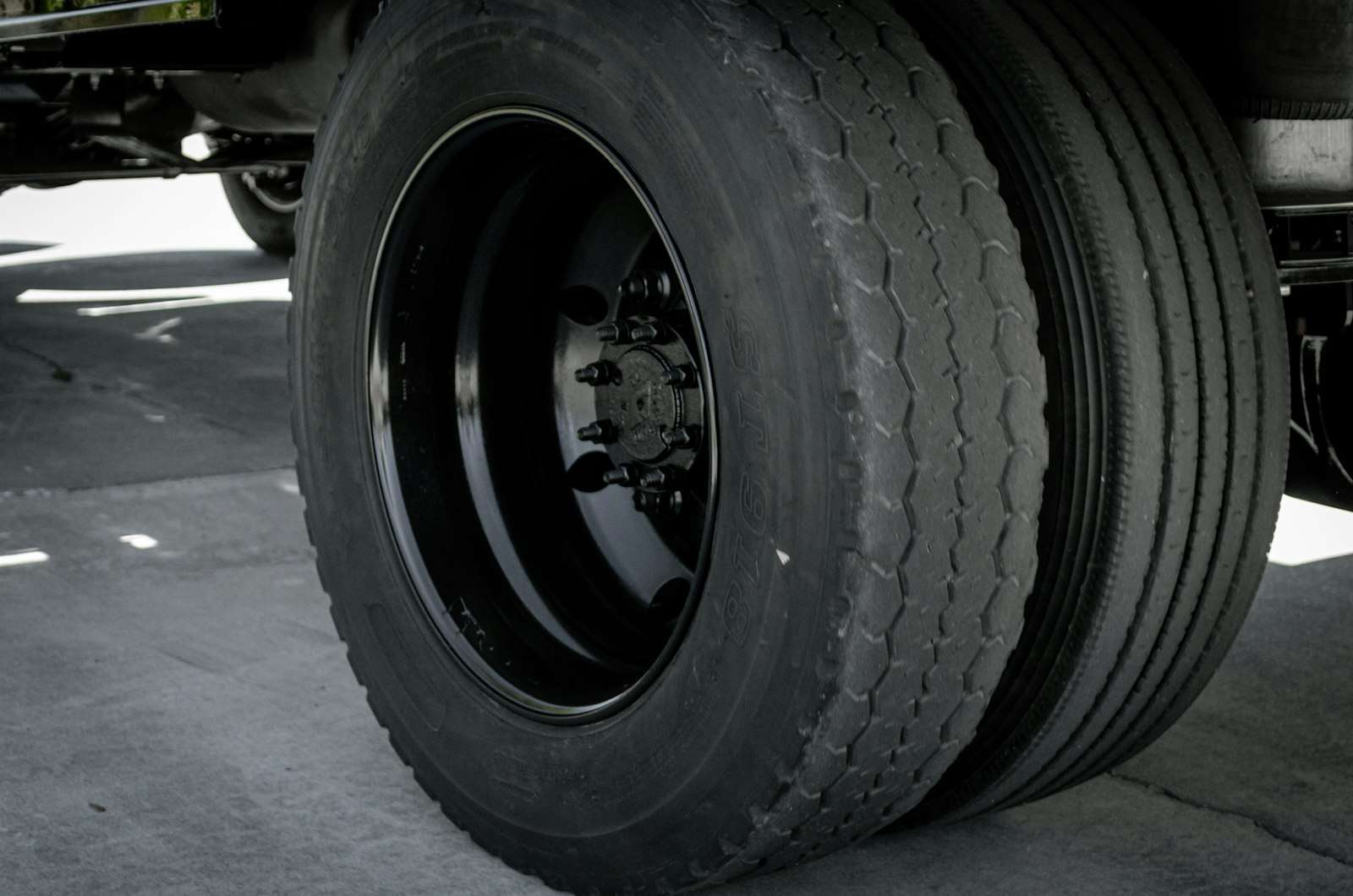 Close-up of a semi truck's dual rear wheels, where brakes that overheat can send it to a runaway truck ramp